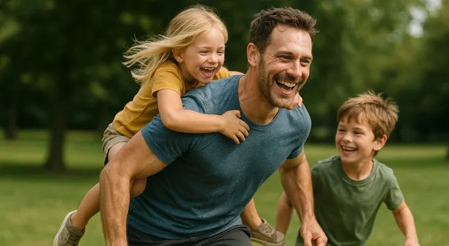 Man playing with two children in a park